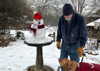 Daisy Mae doesn't know what to think about the snowman!